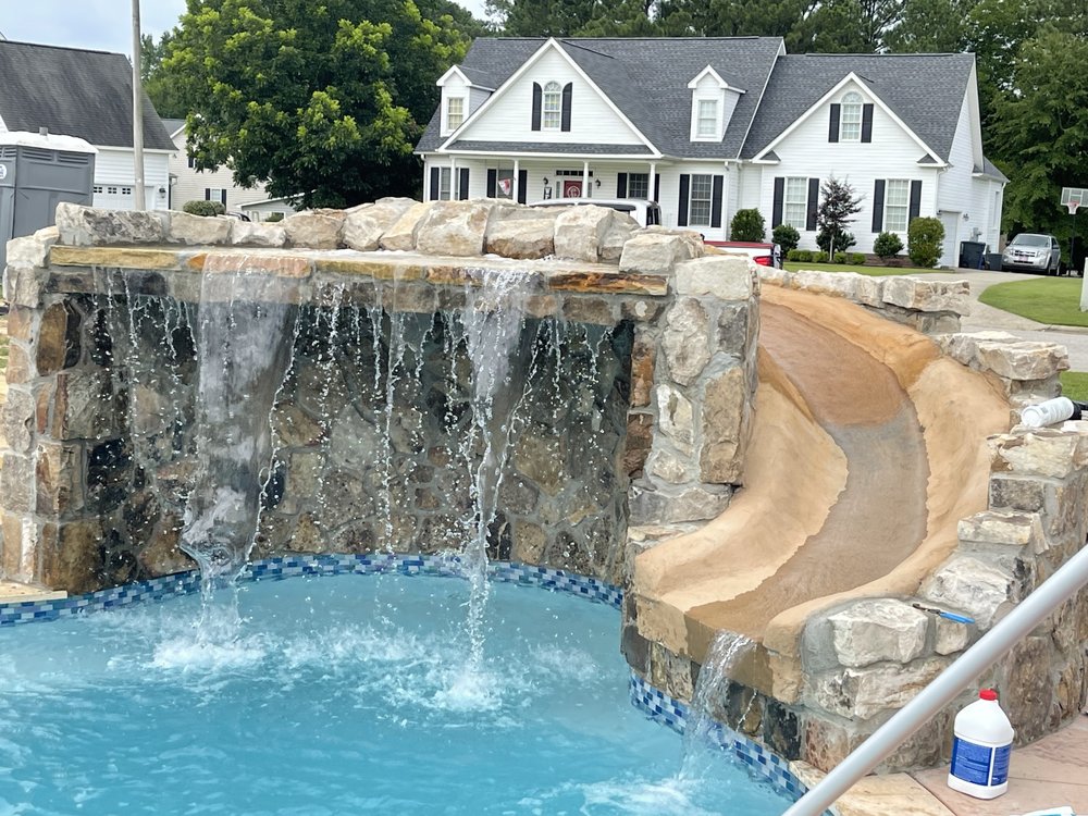 Rock waterfall and slide feature with clear, turquoise water